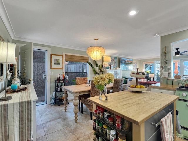 dining room with light tile patterned floors, ceiling fan with notable chandelier, and ornamental molding