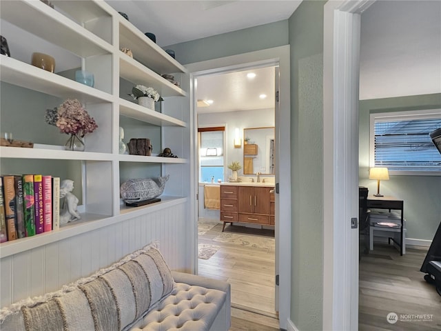 sitting room featuring sink and light hardwood / wood-style floors