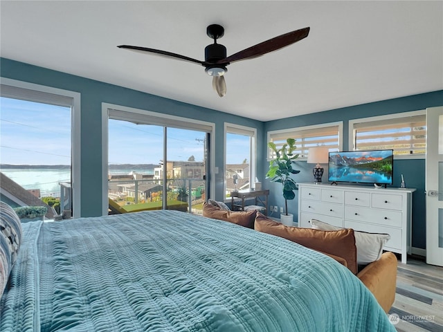 bedroom with access to exterior, ceiling fan, and light hardwood / wood-style flooring