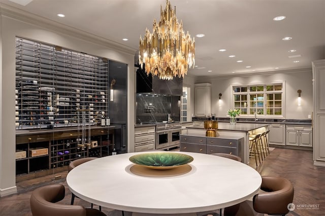 dining room with crown molding, dark parquet floors, and sink