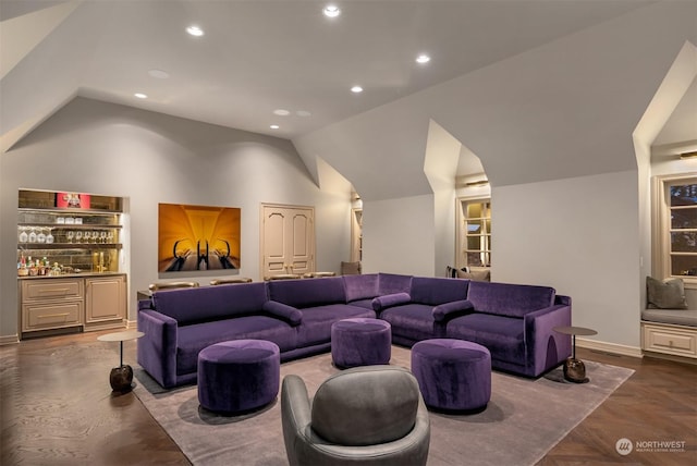 home theater featuring lofted ceiling and parquet floors