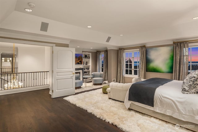 bedroom featuring dark wood-type flooring and a tray ceiling