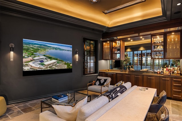 cinema room featuring bar and ornamental molding