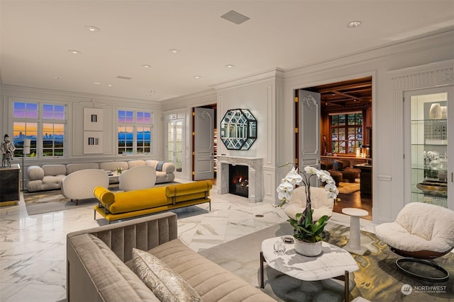 living room with a high end fireplace and crown molding