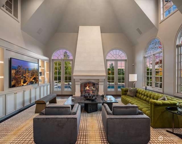 living room featuring french doors, high vaulted ceiling, and a healthy amount of sunlight