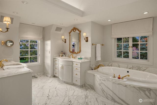 bathroom featuring vanity and tiled bath