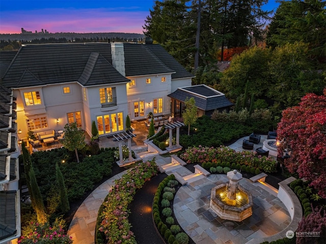 view of back house at dusk