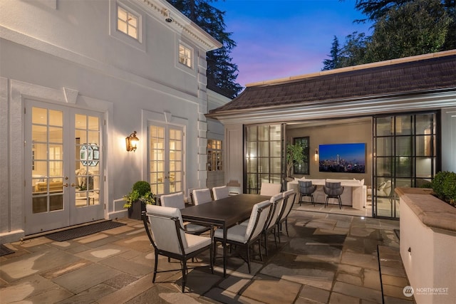 patio terrace at dusk featuring french doors