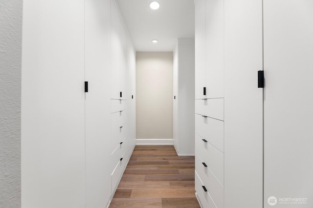 spacious closet with light hardwood / wood-style floors