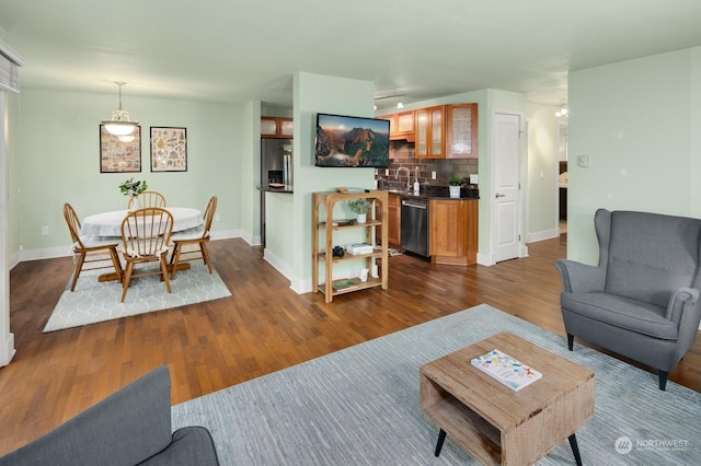 living room featuring dark hardwood / wood-style floors and sink