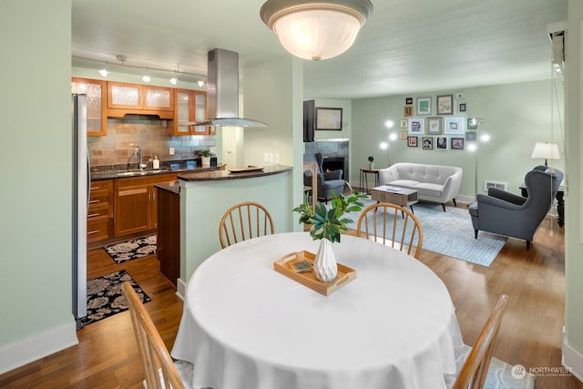 dining area with sink and hardwood / wood-style floors