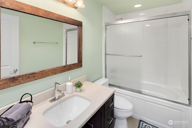 full bathroom featuring toilet, enclosed tub / shower combo, and vanity