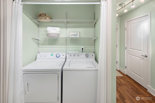 laundry area with dark wood-type flooring and independent washer and dryer