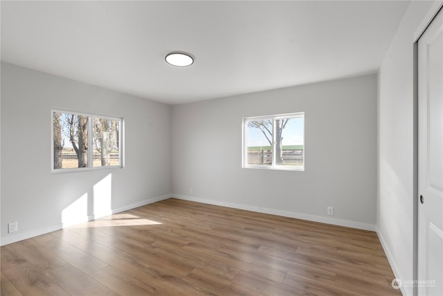 unfurnished room with hardwood / wood-style flooring