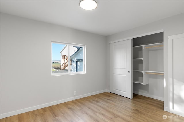 unfurnished bedroom featuring a closet and light wood-type flooring