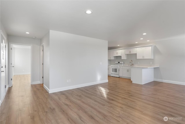 unfurnished living room with light hardwood / wood-style flooring and sink