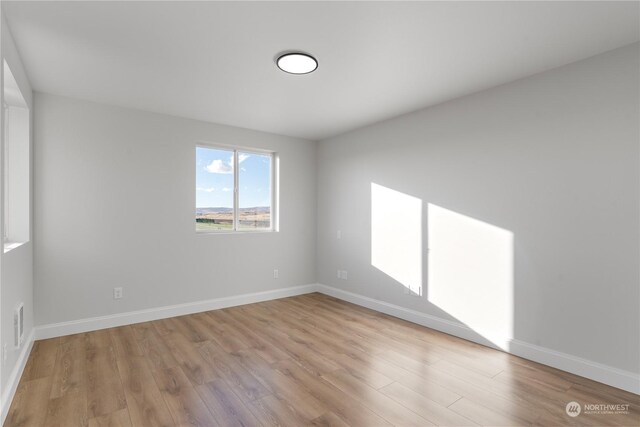 unfurnished room with light hardwood / wood-style floors