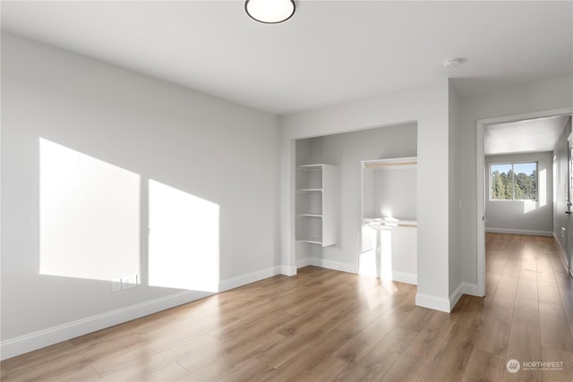 unfurnished bedroom with light wood-type flooring