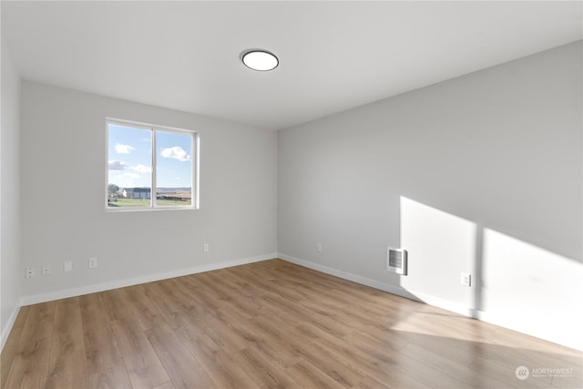 spare room with light wood-type flooring