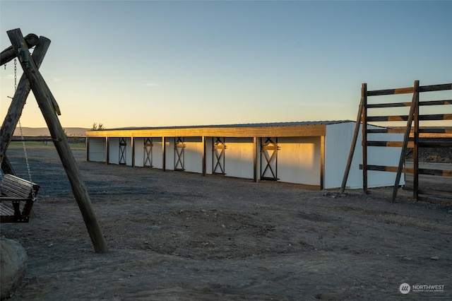 view of garage at dusk