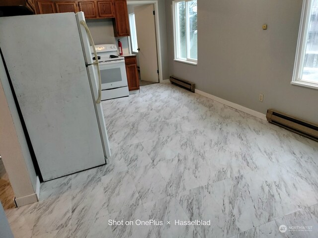 kitchen with white appliances and baseboard heating