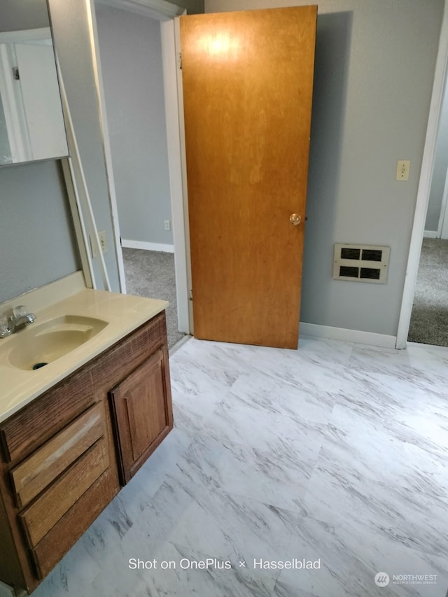 bathroom with heating unit and vanity