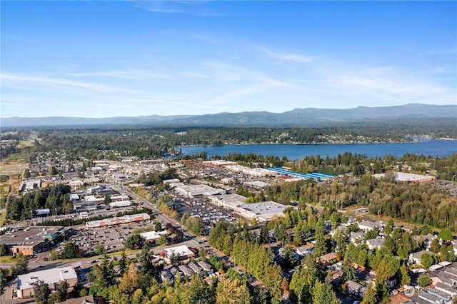 drone / aerial view featuring a water and mountain view