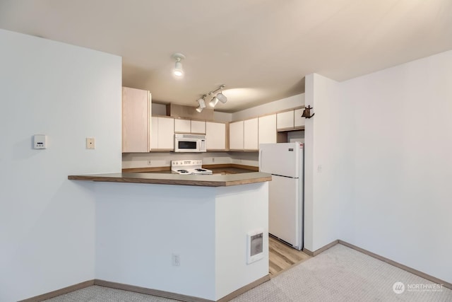 kitchen with white appliances and kitchen peninsula