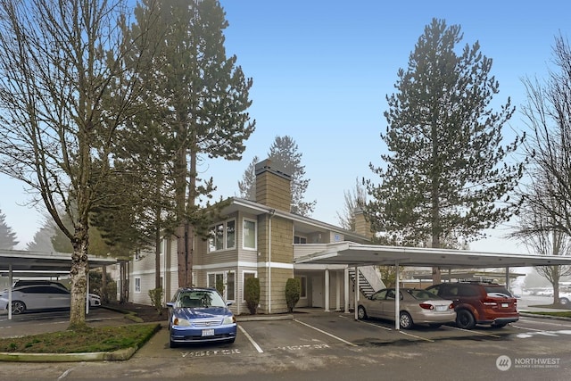 view of parking / parking lot featuring a carport