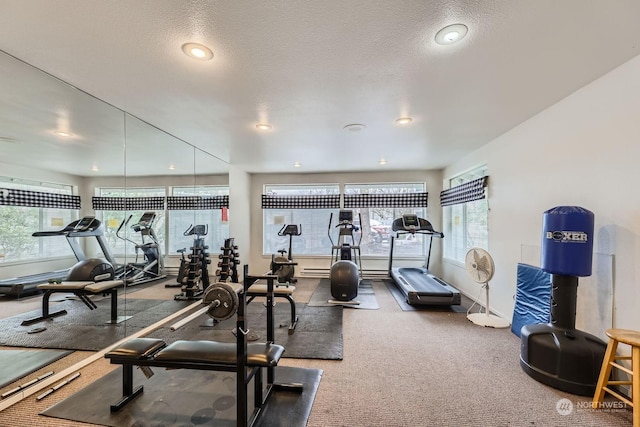 gym featuring carpet flooring and a textured ceiling