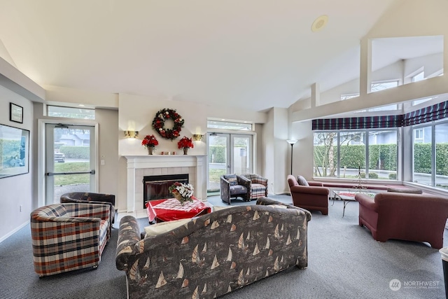 carpeted living room featuring a tile fireplace, lofted ceiling, and a healthy amount of sunlight