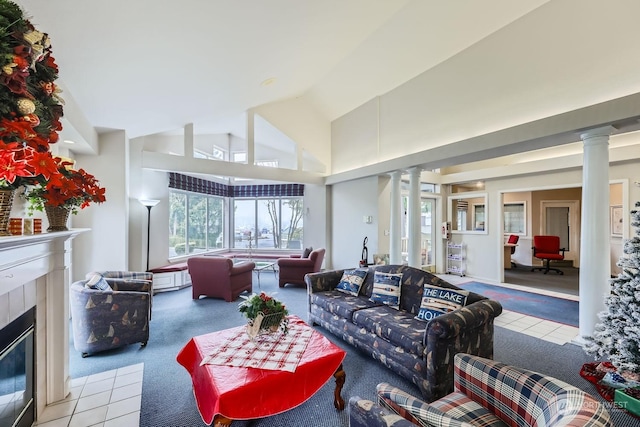 living room featuring a fireplace, high vaulted ceiling, light carpet, and ornate columns