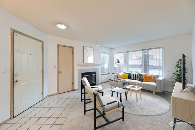 living room with light tile patterned floors and a fireplace