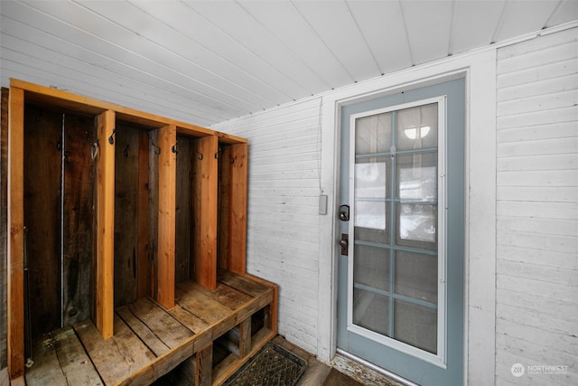 mudroom featuring wooden walls and hardwood / wood-style floors