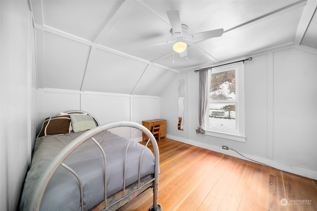 bedroom with ceiling fan, wood-type flooring, and lofted ceiling