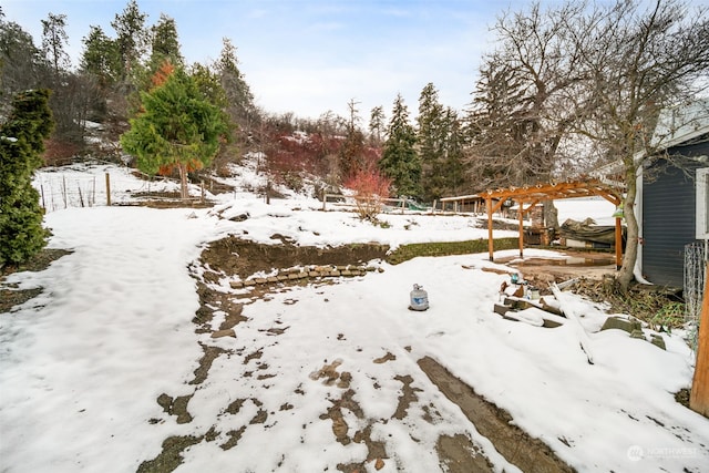 yard covered in snow featuring a pergola