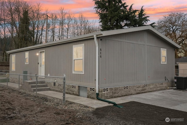 property exterior at dusk featuring central air condition unit