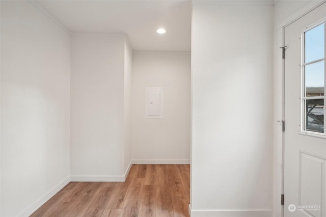 empty room with light hardwood / wood-style floors and ornamental molding