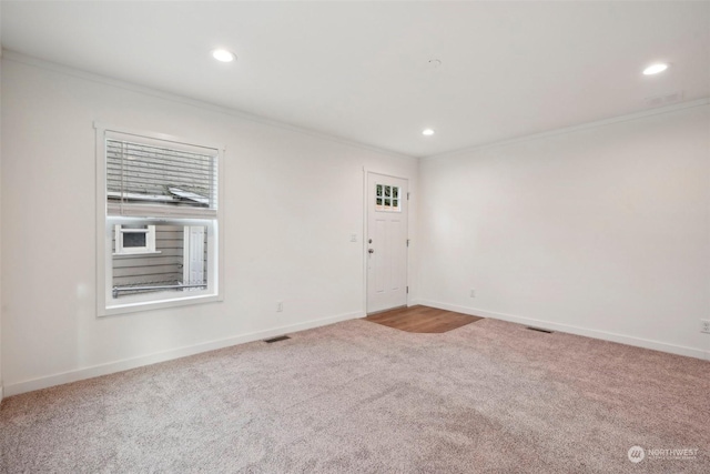 unfurnished room featuring carpet floors and ornamental molding