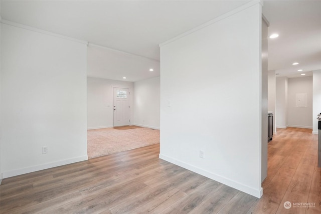 unfurnished room with hardwood / wood-style flooring and ornamental molding