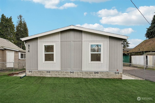 back of house with a lawn