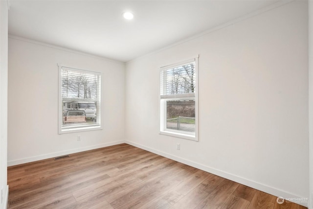 unfurnished room featuring light hardwood / wood-style flooring and ornamental molding