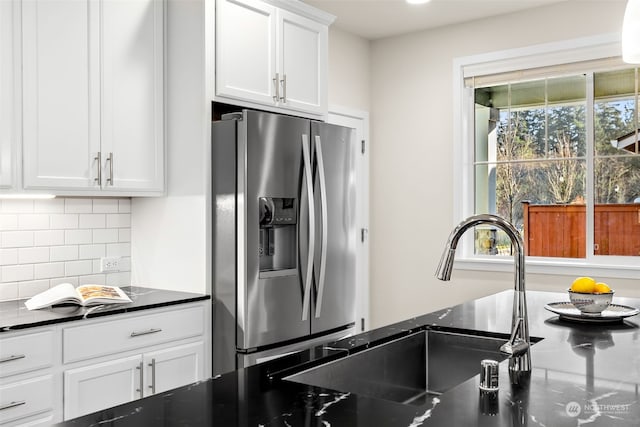 kitchen featuring white cabinetry, sink, stainless steel fridge, and decorative backsplash