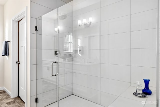 bathroom with a shower with shower door