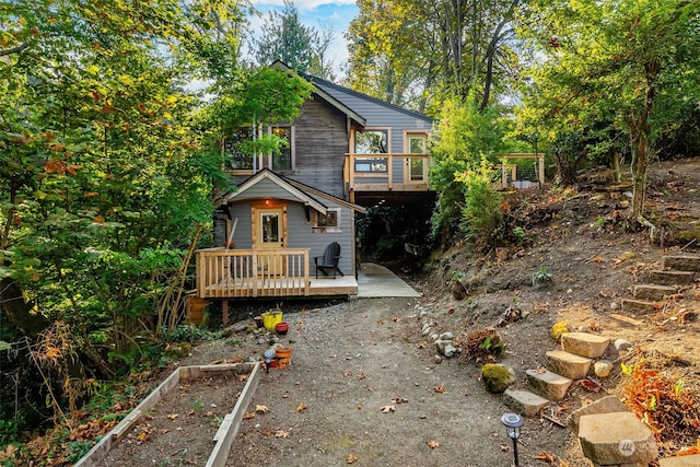 back of house with a wooden deck