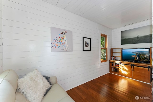 living room with wooden walls and hardwood / wood-style floors