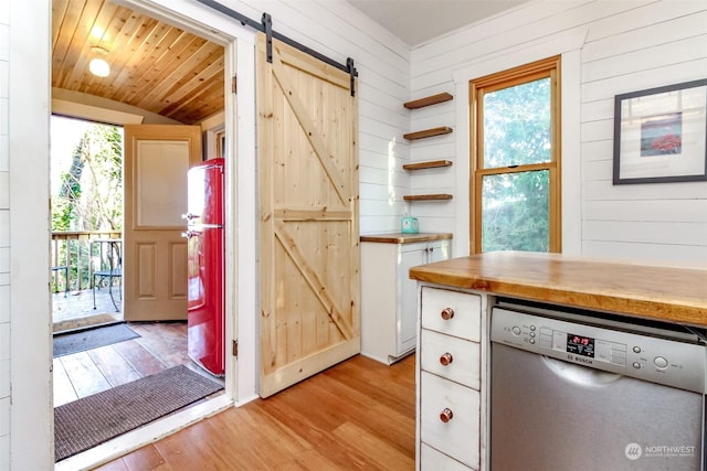 kitchen featuring stainless steel dishwasher, wooden ceiling, light hardwood / wood-style floors, and a barn door