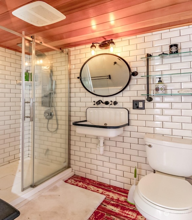 bathroom with an enclosed shower and toilet