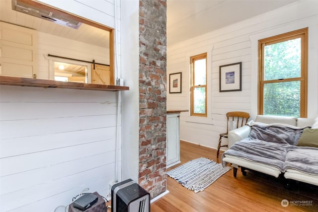 interior space featuring wood walls and hardwood / wood-style flooring