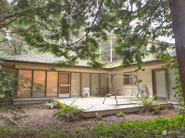 rear view of house featuring a deck